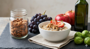 Collection of cholesterol-lowering foods including oats, fish, nuts, olive oil, and fresh vegetables